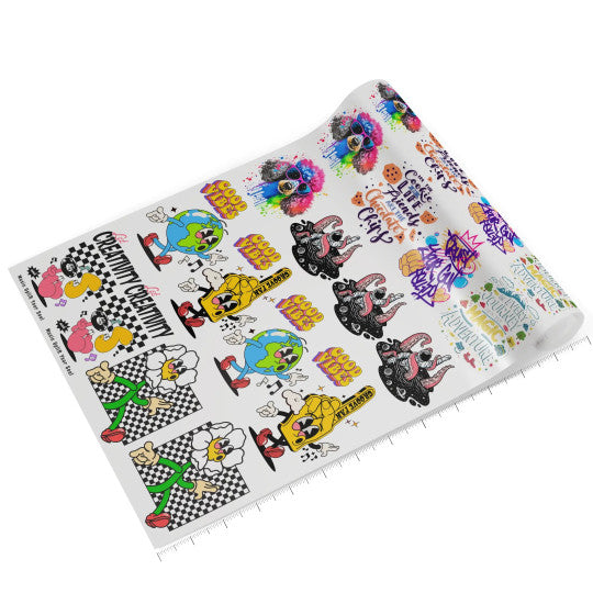 Rolled DTF Gang Sheet with multiple colorful cartoon designs.