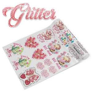 Glitter DTF gang sheet with pink Valentine designs: hearts, cactus, bees, and "Bee Mine" lettering with silver shimmer.
